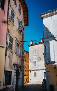 Low angle view of residential buildings against blue sky