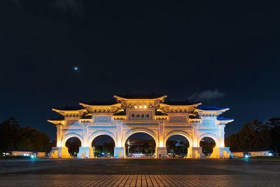 Illuminated building against sky at night