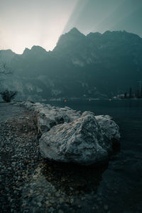 Scenic view of rocks by lake against sky