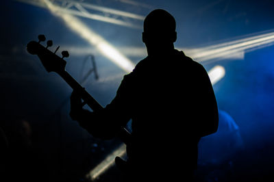 Silhouette man playing guitar