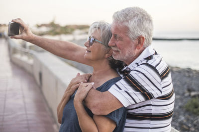Midsection of couple kissing on water
