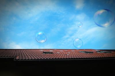 Low angle view of bubbles against moon