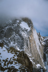 High angle view of snow covered mountains against sky during winter