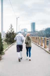 Young sports couple running in the urban environment. young fitness couple runner running 