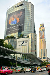 View of city street and buildings against sky