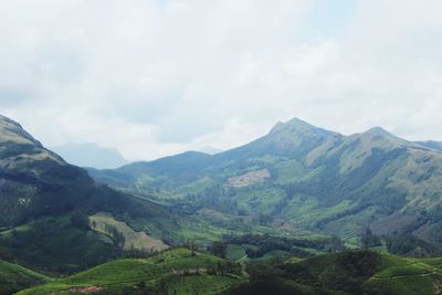 Scenic view of mountains against cloudy sky