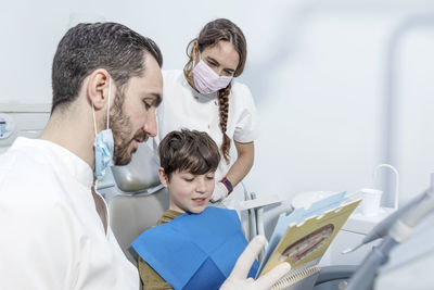 Female doctor examining patient in clinic