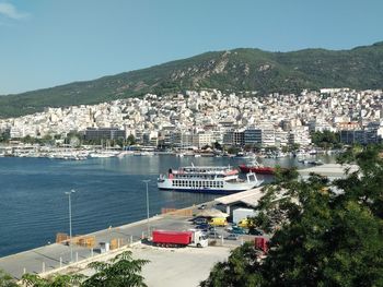 High angle view of city by sea against sky