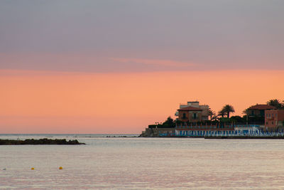 Scenic view of sea against orange sky