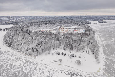 Aerial view of snow covered landscape against sky