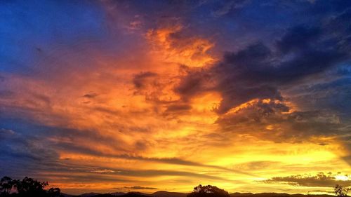 Low angle view of cloudy sky at sunset