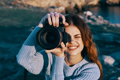 Portrait of woman photographing