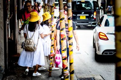 Rear view of women standing on street