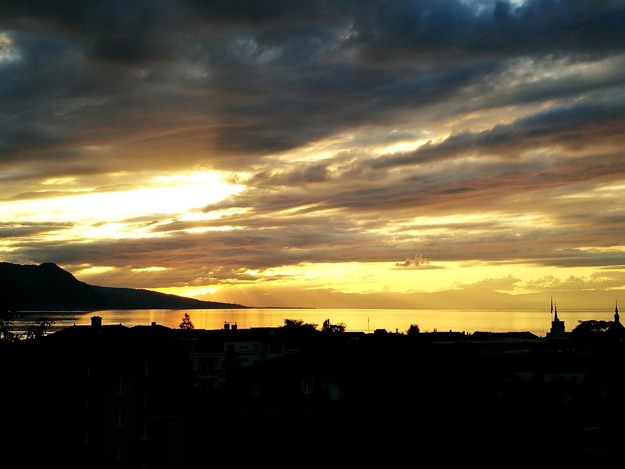 SILHOUETTE LANDSCAPE AGAINST DRAMATIC SKY