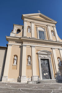 Low angle view of building against clear blue sky