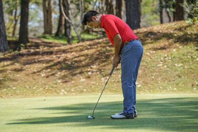Side view of person standing on golf course