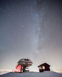 Lifeguard hut on sea against sky at night