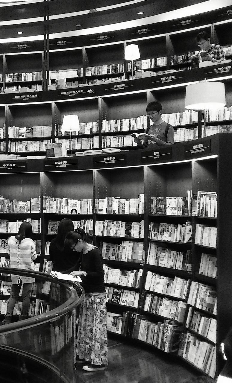 indoors, architecture, built structure, railing, incidental people, retail, men, building exterior, shopping, high angle view, day, store, restaurant, public transportation, text, market, city, transportation, ceiling