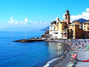 Panoramic view of sea against buildings