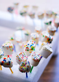 Marshmallow dipped chocolate and colorful sprinkles.