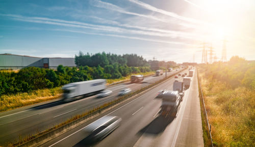 Cars on road in city against sky