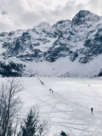 Scenic view of snow covered mountains against sky