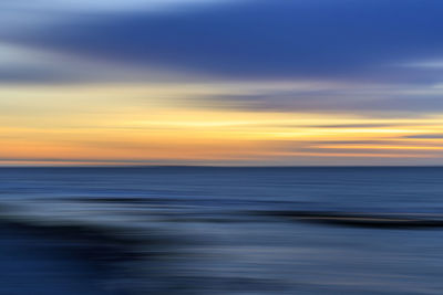 Scenic view of sea against sky at sunset