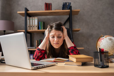 Young woman using phone at home