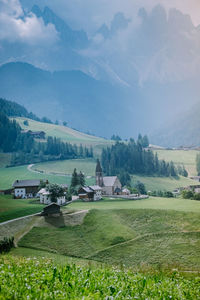 Scenic view of field by mountains against sky