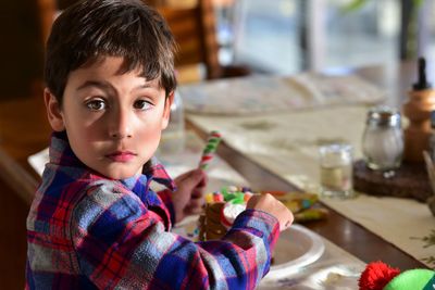 Portrait of cute boy having dessert at home