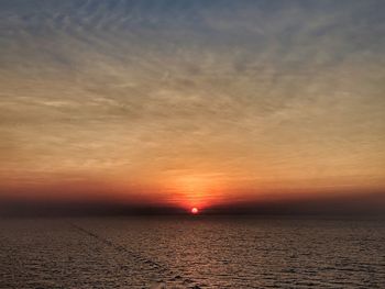 Scenic view of sea against romantic sky at sunset