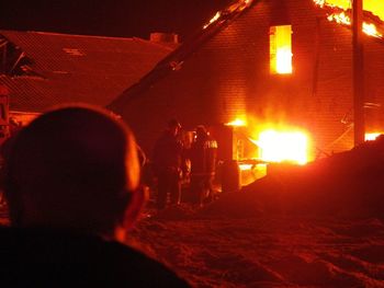 Rear view of people in illuminated city at night
