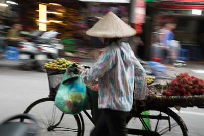 Rear view of woman walking on street in city