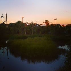 Reflection of factory on water at sunset