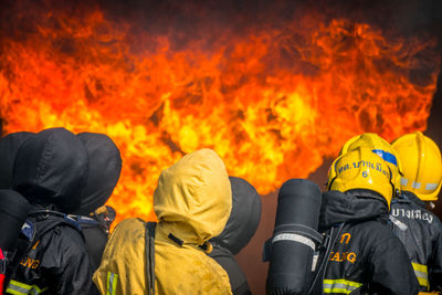 Rear view of firefighters extinguishing fire