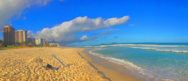 Panoramic view of calm beach against blue sky