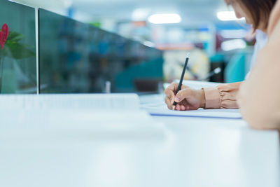 Midsection of woman working on table