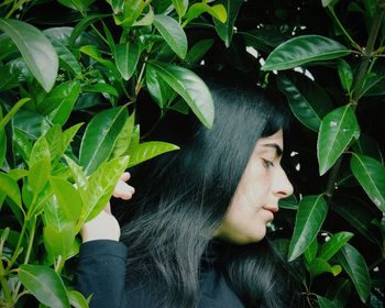 Portrait of woman with green leaves