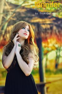 Portrait of a beautiful young woman standing outdoors