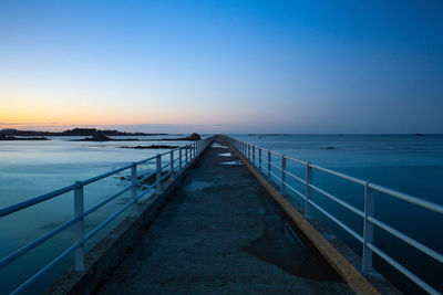 Scenic view of sea against clear sky during sunset