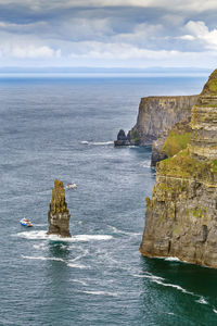 Rock formation in sea against sky