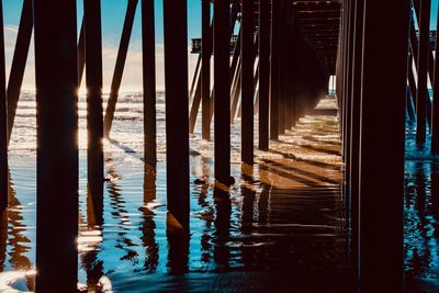 Wooden posts in sea