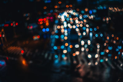 Defocused image of illuminated city at night