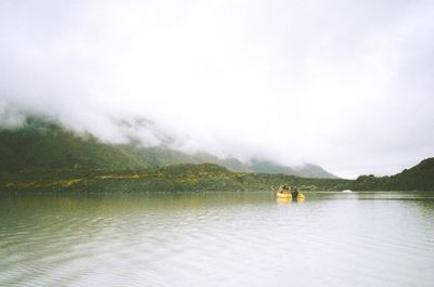 Scenic view of lake against cloudy sky