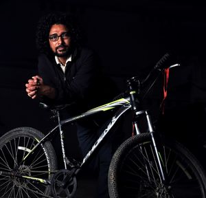 Portrait of young man riding bicycle