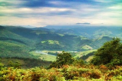 Scenic view of mountains against cloudy sky