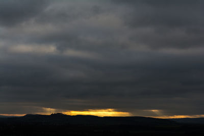 Scenic view of dramatic sky at sunset