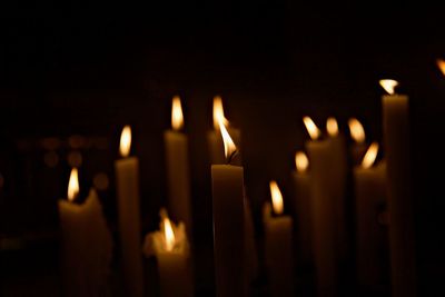 Close-up of burning candles in temple