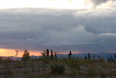 Scenic view of land against sky during sunset