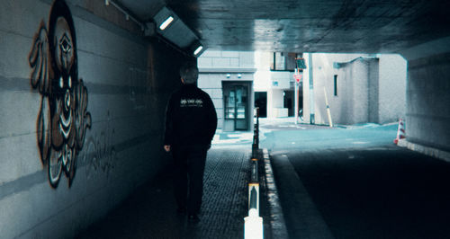 Rear view of silhouette person walking in subway